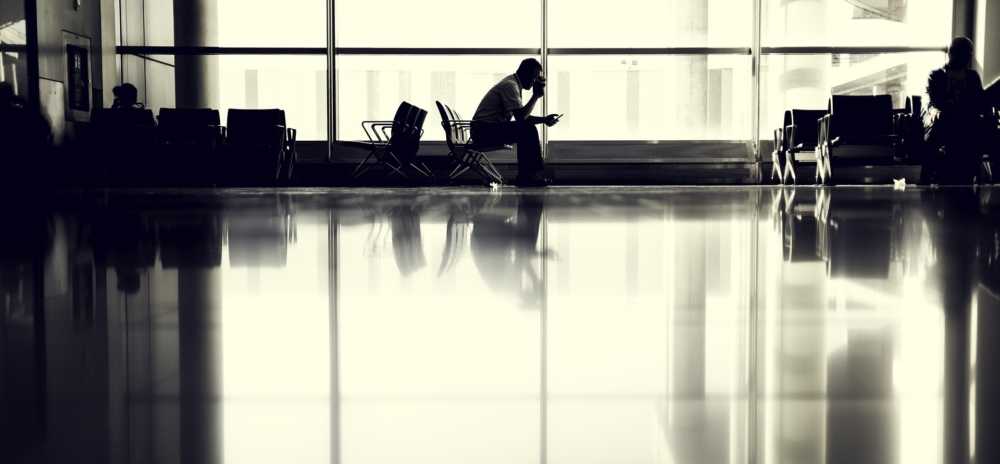 Traveler using WiFi in airport terminal